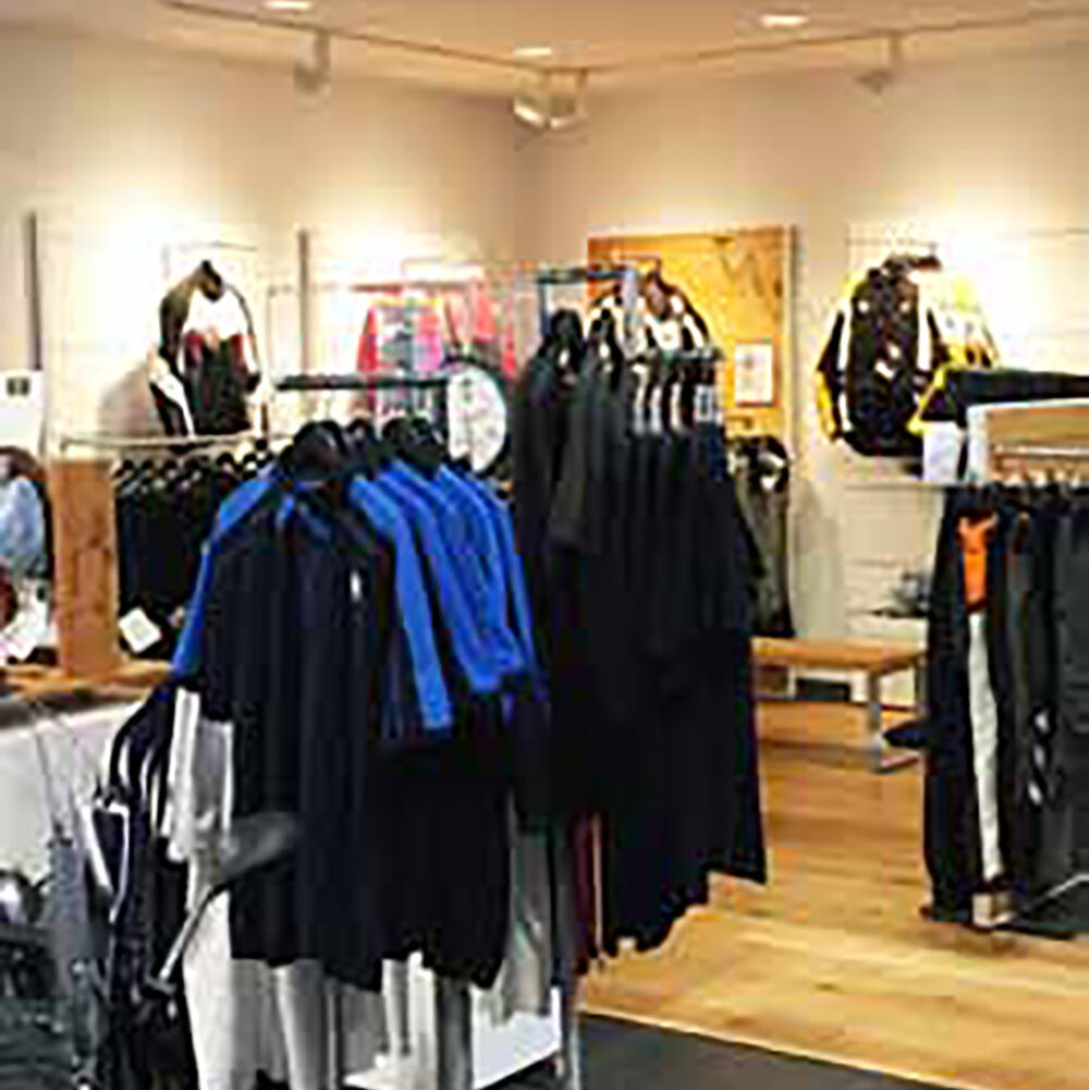 Shirts and merchandise neatly arranged inside a new showroom design at Battley Cycles in Gaithersburg, MD.